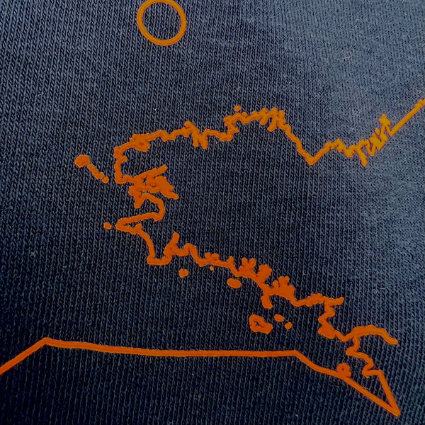 close up Breizh knitting frame on navy blue sweat shirt